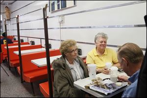 Becky Hackworth, left, Donetia Hurt, center, and Douglas Hurt, right, all of Lima, chat at the Kewpee hamburger restaurant. The three voted for President Obama in 2008, but since have turned their support to Mitt Romney.
