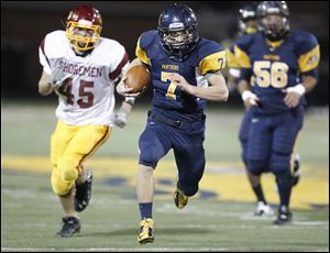 Whitmer quarterback Nick Holley, 7, outraces the Avon Lake High School defense for a touchdown in the fourth quarter.
