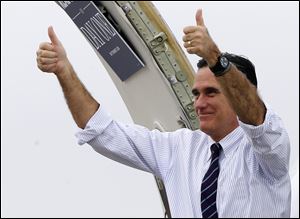 Republican presidential candidate, former Massachusetts Gov. Mitt Romney gives two thumbs up as he boards his campaign plane after a Florida campaign rally in Sanford, Fla., enroute to Virginia.