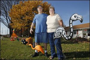 John & Bonnie Tursich with their collection of flamingos at their Perrysburg Township home.