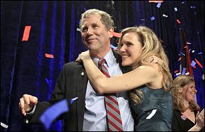 Sen. Sherrod Brown is hugged by his daughter, Liz,  as they celebrate his re-election Tuesday night. Mr. Brown called his victory a triumph for the middle class.