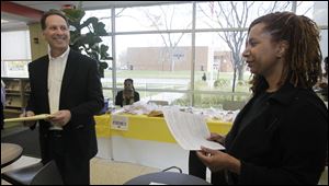 Jay Feldstein, an observer at the Kent Branch of the Toledo-Lucas County Public Library, spoke with Valentina Beene, 35, of Toledo. Beene had had to vote provisionally after having been removed from the rolls, despite having voted at Kent in previous elections. 