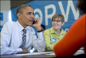 President Obama calls to thank volunteers in Wisconsin, at campaign office call center the morning of the 2012 election in Chicago. Carla Windhorst is seated next to the president. 