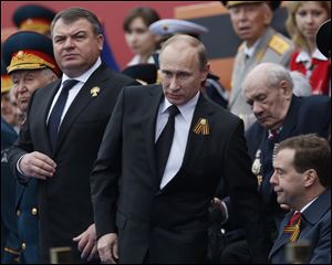 Russian President Vladimir Putin, left, has fired the country's defense minister Anatoly Serdyukov, right, two weeks after a criminal probe was opened into alleged fraud in the sell-off of military assets. Putin made the announcement of Serdyukov's dismissal today in a meeting with Moscow regional governor Sergei Shoigu, whom he appointed as the new minister. 
