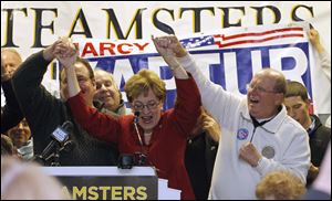 Congresswoman Marcy Kaptur celebrates her victory with supporters at the Teamsters Union Hall in Toledo. To her left is Bill Lichtenwald, president of Teamsters Local 20, and on her right is George Tucker, executive secretary of Greater NW Ohio AFLCIO.