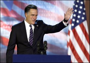 Republican presidential candidate and former Massachusetts Gov. Mitt Romney waves to supporters before conceding at his election night rally.