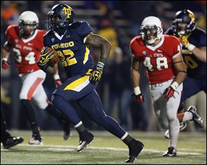University of Toledo RB David Fluellen scores a touchdown against Ball State during the fourth quarter Tuesday at the Glass Bowl in Toledo..