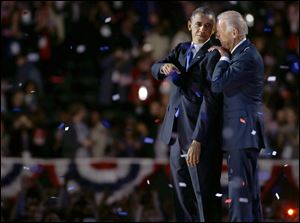 Vice President Joe Biden, right, talks to President Barack Obama after the president's victory speech Wednesday in Chicago.