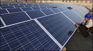 Solar panels undergo inspection at a factory in Qingdao, east China’s Shandong Province. A federal trade panel found China responsible Wednesday for harming the U.S. solar panel industry.