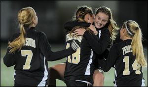 Perrysburg's Lindy DeLong celebrates in the arms of Allex Brown (18) as Beth Glowacki (7) and Abby Stattler (14) join in after Perrysburg beat Strongsville 2-0 in the girls Division I state semifinal.