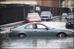 Cars sit in flood water as a result of superstorm Sandy Oct. 30 in Hoboken, NJ.