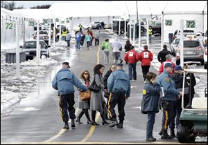New Jersey Commissioner of the Department of Human Services, Jennifer Velez, center, walks near rows of large tents Thursday in Oceanport, in Monmouth County, N.J., as she tours the facilities. New Jersey is moving some Superstorm Sandy evacuees from shelters to tent-like housing at Monmouth Park, a racetrack.