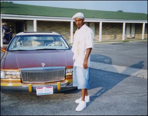 A young Wayne Banks, Jr., stands next to his Cadillac outside a motel. Banks made his fi rst ‘pimp dollar’ at the age of 16, using a prostitute who was about 20.