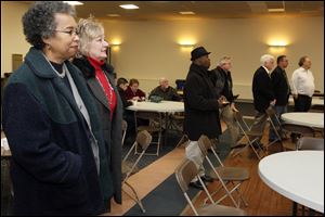 Brenda Hill, TPS Vice President, left, and Lisa Sobecki, TPS President, right, join other members of the Board while waiting for the TPS levy results to come in Tuesday.