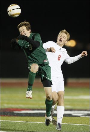 Ottawa Hills' Dan Reilly (3) moves the ball against  Gates Mills Hawken's Patrick Connors during a  Division III boys state soccer semifinal Wednesday in Sandusky, Ohio.