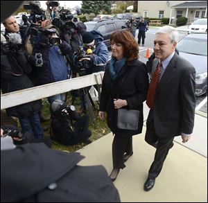 Former Penn State University President Graham Spanier and his wife Sandra enter Harrisburg, Pa. District Judge William Wenner's office Wednesday.