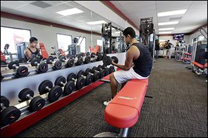 A customer works out at Snap Fitness Rolling Strong Gym at a truck stop in Dallas. In addition to fitness centers, some programs are mapping out exercise routes at truck stops and fast food restaurants are offering tips on how to spot healthy menu items.