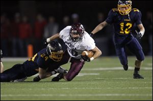 Ryan Espinoza, of the Genoa Comets, gets tackled during the first quarter of their game against the Ottawa-Glandorf Titans at JC Donnell Memorial stadium in Findlay.