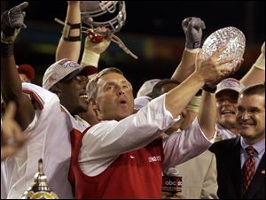 Coach Jim Tressel and Ohio State celebrated a BCS championship with a 31-24 double-overtime victory against Miami in January, 2003. That team will be honored Nov. 24 in Columbus.