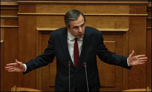 Greece's Prime Minister Antonis Samaras delivers a speech during a parliament meeting for vote on 2013 country's budget Sunday in Athens. The budget passed by a 167-128 vote in the 300-member Parliament.