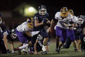 Max Westhoven, of the Napoleon Wildcats, runs the ball during the second quarter of their Division III playoff game against the Bryan Golden Bears at Gallagher Stadium in Toledo Saturday.