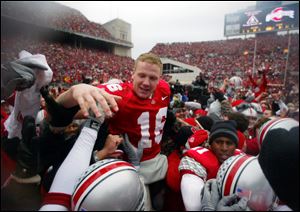 Ohio State quarterback Craig Krenzel is carried across the field by teammates and fans after the Buckeyes beat Michigan, 14-9, in this Nov . 23, 2002 file photo, in Columbus.