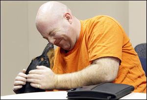 Veteran Earl Henrick, from Wixom, MIch., greets Rylan, a Doberman with the Canine Advocacy Program who visits the vets twice a month.