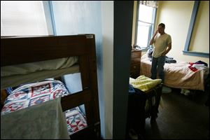 Homeless veteran Harleigh Marsh stands in his shared room at Scott Place shelter in Fairmont, W.Va. A new partnership among several agencies in Toledo aims to prevent homelessness among veterans. The initiative, funded by the Toledo Community Foundation, provides a representative-payee service to area veterans — a service to help manage finances for those who qualify for a benefit check but aren’t able to adequately handle their own spending and household expenses.
