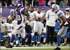 Vikings running back Adrian Peterson eludes Lions safety Ricardo Silva to score on a 61-yard touchdown run in the second half on Sunday. He finished with 171 yards rushing.
