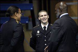 Shonn Monday, of the Rocket Battalion ROTC, talks with Mayor Michael Bell after the eighth annual Veterans Appreciation Breakfast and Resource Fair in Savage Arena at the University of Toledo.