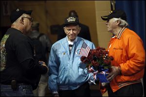 Korean War Veteran Henry Bahler, center, listens as two vietnam veterans talk amongst each other after the eighth annual Veterans Appreciation Breakfast and Resource Fair in Savage Arena at the University of Toledo.