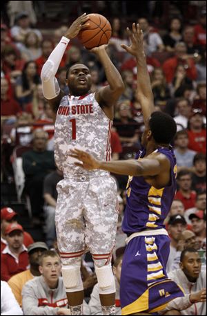 Ohio State's Deshaun Thomas, left, shoots over Albany's Jayson Guerrier during the Buckeyes' 82-60 victory Sunday in Columbus.