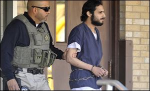 Khalid Ali-M Aldawsari, 22, right, is escorted from the federal courthouse in Amarillo, Texas by U.S. Marshals Tuesday.
