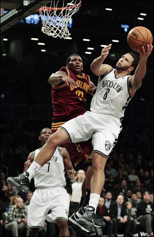 Brooklyn Nets' Deron Williams drives past Cleveland Cavaliers' Alonzo Gee during the first half tonight in New York.