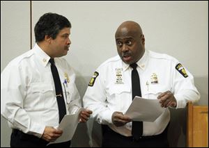 The Toledo Fire and Rescue chief, Luis Santiago, left, and Toledo Police Chief Derrick Diggs, right, attend the announcement for the proposed 2013 operating budget at One Government Center.