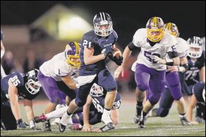 Napoleon’s Max Westhoven runs the ball against Bryan. He has gained 481 yards. He leads the Wildcats with 84 tackles.