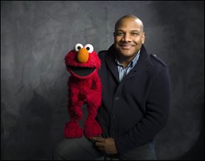 Elmo puppeteer Kevin Clash with the 'Sesame Street' muppet.