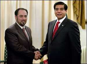 Salahuddin Rabbani, left, head of Afghanistan High Peace Council, shakes hand with Pakistan's Prime Minister Raja Pervaiz Ashraf prior to their meeting in Islamabad, Pakistan, Monday.