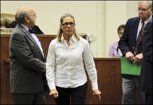 Former Dixon, Ill., comptroller Rita Crundwell leaves a courtroom in Dixon with her attorney Paul Gaziano, left, in October, after making her first appearance in the northern Illinois city to face charges she siphoned millions of dollars in public funds into a secret bank account.