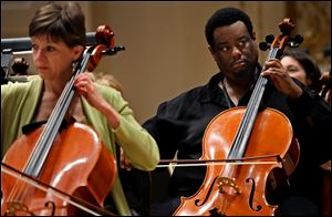 Cello players Martha Reikow, left, Damon Coleman, right, members of the Toledo Symphony (TSO), prepare during a rehearsal Saturday, May 7, 2011, for an evening performance at Carnegie Hall in New York. The performance will also include the Cold War-themed political play, Every Good Boy Deserves Favour as part of the program, with actors taking the stage with the TSO.