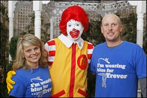 Jill and Nathan Bailey, of Defiance, pose for a photograph with Ronald McDonald during the the 4th Annual Heartwarming Party to benefit Ronald McDonald House Charities. The event, which drew hundreds of people, was held at the Hilton Garden Inn at Levis Commons in Perrysburg.