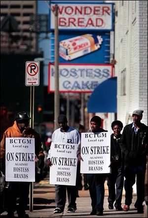 Members of the Bakery, Confectionery, Tobacco, and Grain Millers union picket outside a Hostess bakery in Memphis. The strike began Nov. 9 after a bankruptcy judge imposed concessions.