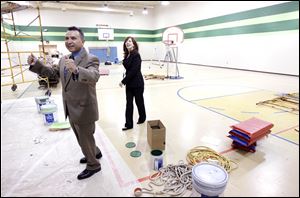Ron and Cathy Tijerina show off the former Hope School gym, which is being painted. They plan to make the gym available for family events and Special Olympics as well as the Ridge Project's programs.