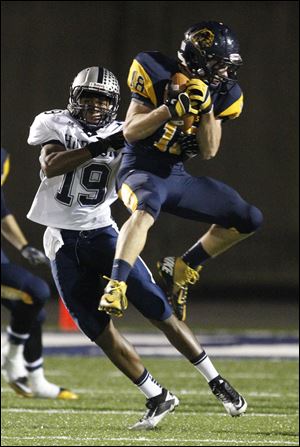 Whitmer's Nate Holley intercepts a pass intended for Hudson's Leighton Antonio. The Panthers have allowed an average of just 8.6 points per game.