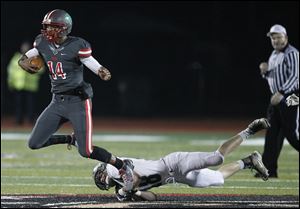 Central Catholic's DeShone Kizer gets past Mansfield Madison's Seth Gowitzka. Kizer has scored four TDs and passed for six in the playoffs.
