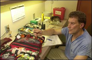 Dr. Tim Reichard, shown at the Toledo Zoo in this 2000 photo, says he always felt that everyone responsible for animal care at the zoo had to work together as a team.