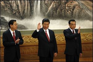 Members of the new Politburo Standing Committee Zhang Dejiang, left, Xi Jinping, Li Keqiang meet journalists in Beijing's Great Hall of the People. The seven-member Standing Committee, the inner circle of Chinese political power, was paraded in front of assembled media on the first day following the end of the 18th Communist Party Congress. 