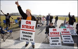 Randy Moore and other employees of the Hostess plant in Northwood picket Thursday.