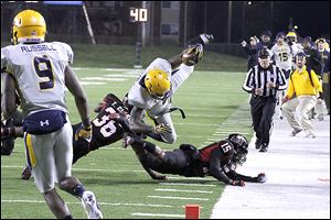 Rocket's tight end Cordale Scott dives for a first down in the second quarter Wednesday in DeKalb, Ill.