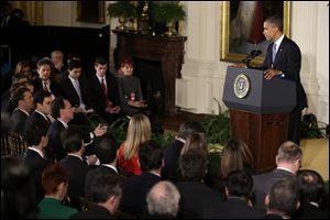 President Barack Obama listens to a reporter's question during a news conference Wednesday in the East Room of the White House in Washington.